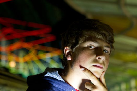 Teenager thinking and looking at camera at Chicago International Airport