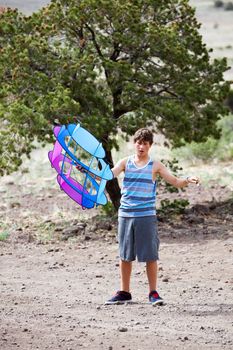 Teenager getting ready to fly his Kite in the country