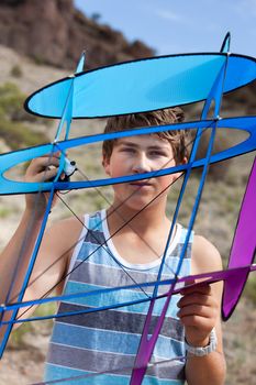 Teenager Looking through his Kite