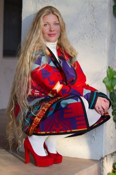 Beautiful Woman wearing southwestern Jacket and red high heels