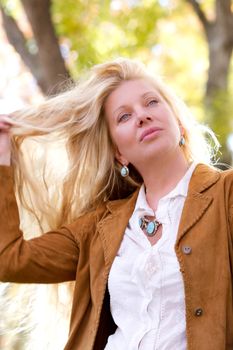 Pretty Woman with Long Hair in fall leaves