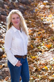 Pretty Woman with Long Hair in fall leaves