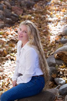 Pretty Woman with Long Hair in fall leaves