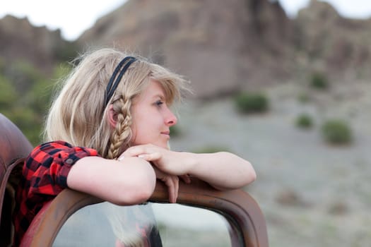 Pretty Blonde Girl in a Vintage old truck in dreamy thought