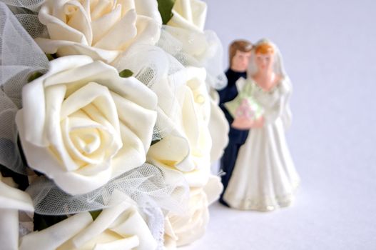 Wedding decoration - white roses bouquet, rings, bride and groom