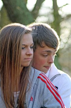 teenagers in the woods looking worried