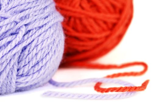 Macro shot of ballsl of puple and orange wool or yarn, great colorful craft background.
