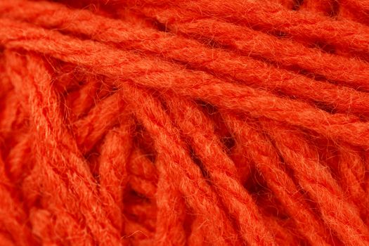 Macro shot of ball of orange wool or yarn, great colorful orange abstract background.