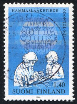 FINLAND - CIRCA 1984: stamp printed by Finland, shows Dentists Examining Patient, circa 1984
