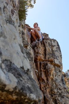 Woman climbing up lions head, cape town, south africa