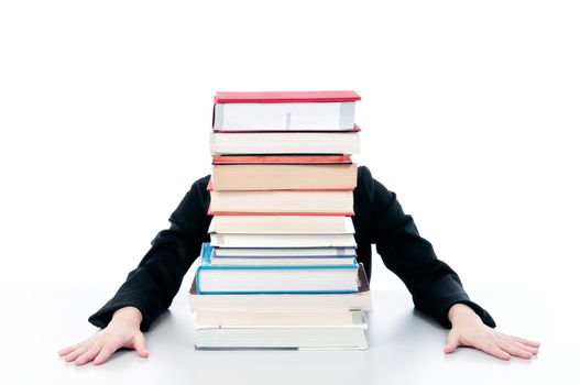 Woman behind stack of books against white background.