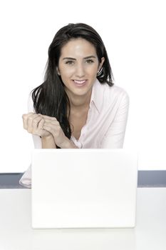 Beautiful young woman sat at white table with her laptop computer