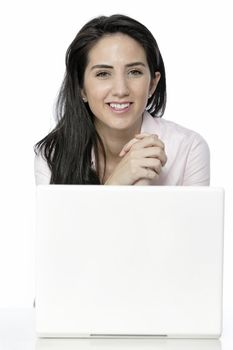 Beautiful young woman sat at white table with her laptop computer