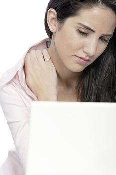 Beautiful young woman with neck pain at her office desk