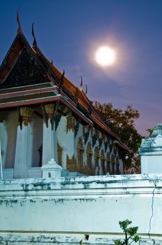 A Wat during night with full moon in the sky. Ayutthaya city is the capital of Ayutthaya province in Thailand. Its historical park is a UNESCO world heritage.