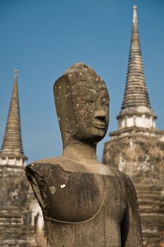 Stupa (chedi) of a Wat in Ayutthaya, Thailand, with Buddha staue. Ayutthaya city is the capital of Ayutthaya province in Thailand. Its historical park is a UNESCO world heritage.