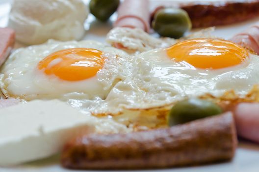 closeup of eggs and hotdog breakfast on the plate, shallow dof - focus on eggs