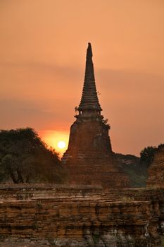 Stupa (chedi) of a Wat in Ayutthaya, Thailand, during sun set
