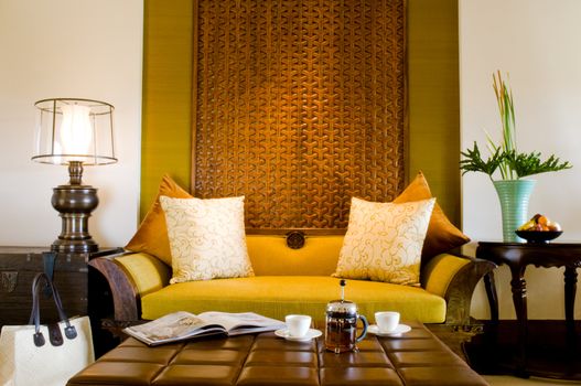 Contemporary living area resort hotel suite room with fruits and tea