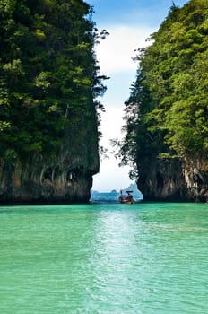 Turquoise lagoon in Thailand with a boat in the background