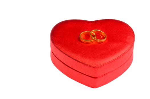 Golden wedding rings on a heart shape box