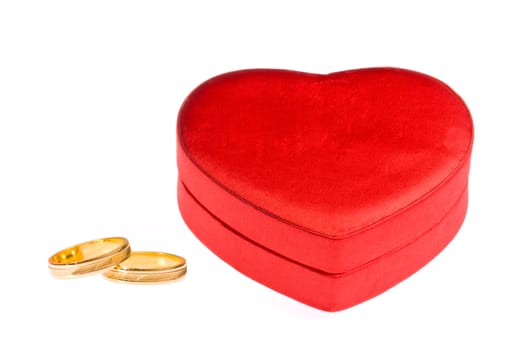 Golden wedding rings and a heart shape box