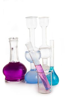Test tubes and flasks with colorful liquids on white
