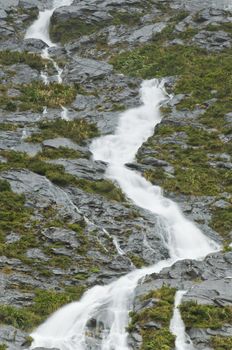 Waterfall during rain showers from a under normal case dry mountain
