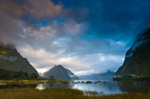Cloudy morning at milford sound with sunrise in the back ground