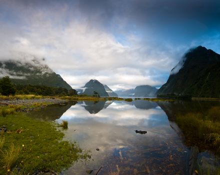 Cloudy morning at milford sound with sunrise in the back ground