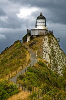 Nugget Point Light House an dark clouds in the sky, Catlins, New Zealand