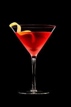 Cosmopolitan cocktail in nice red color in front of a black background 