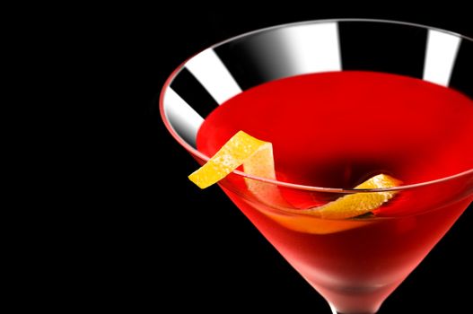 Cosmopolitan cocktail in nice red color in front of a black background