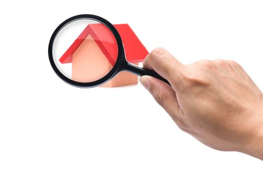 Looking with a magnifying glass on the red roofed house over white