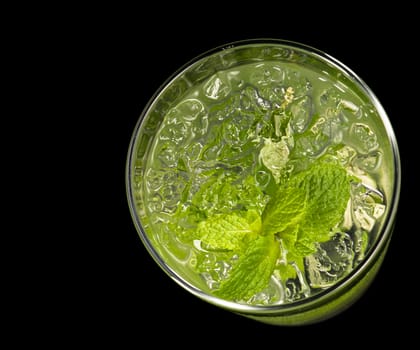 Mojito cocktail in front of a black background