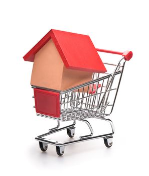 Shopping cart with red roofed house over white