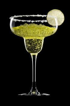 Classic Margarita in front of a black background with fresh garnish
