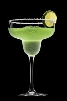 Green Margarita in front of a black background with fresh garnish