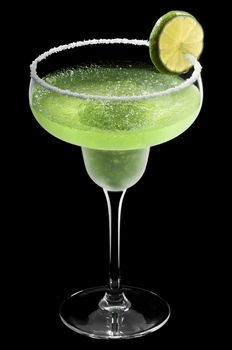 Green Margarita in front of a black background with fresh garnish