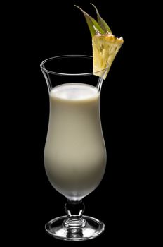 Pina colada over black in a beautiful long drink glass