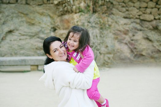 happy mom and daughter smiling at nature