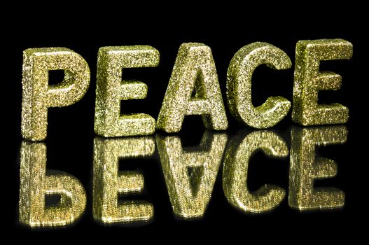 In capital letter written peace, glitter effect over black