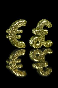 Golden glitter Euro and British Pound symbol, over black