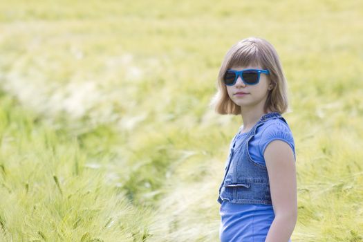 young girl in the field of barley 