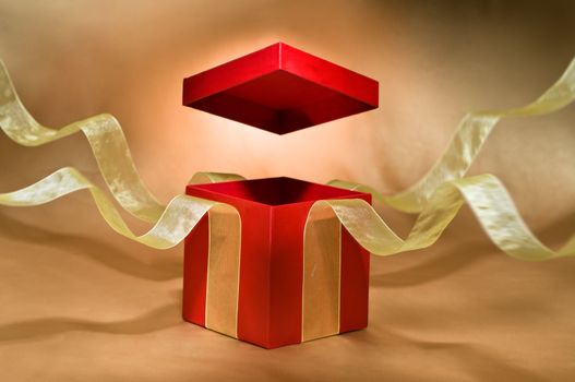 Red Present Box with open cover and yellow flying ribbon