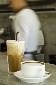 Iced café late and cappuccino on a bar counter, shallow depth of field 