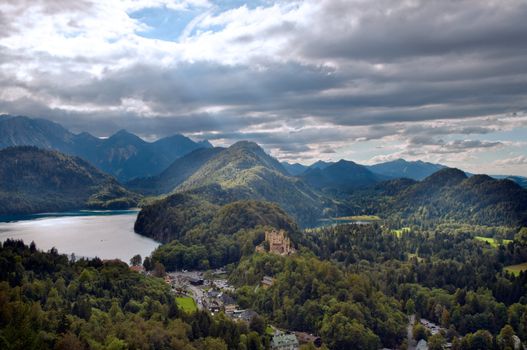 Castle Hohenschwangau with alps in the background in autumn