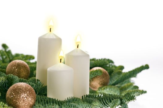 Three candles in advent setting with real Christmas tree branches