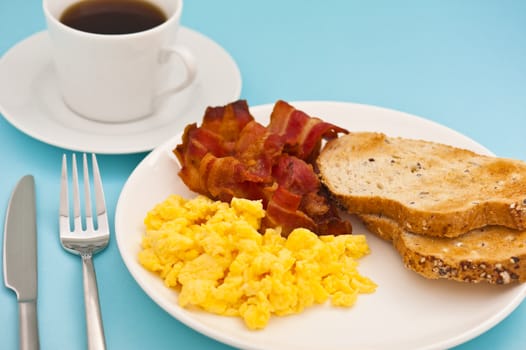 American breakfast, bacon and scrambled egg, with a cup of coffee