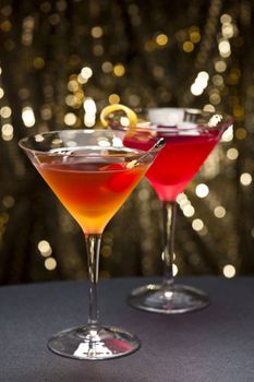 Comopolitan and Manhattan cocktail nice garnished with gold glitter back ground